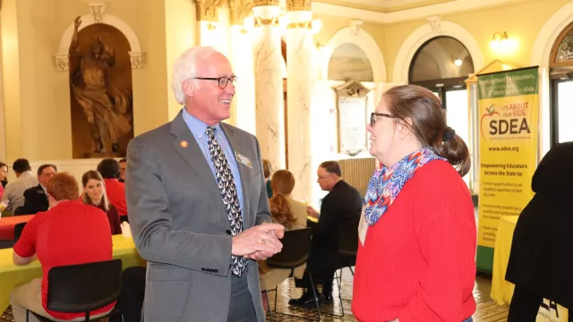 An SDEA member has a conversation with a legislator at the 2022 Lobby Day.